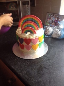 Placed the Rainbows on top and coveted the sides with the fondant hearts.